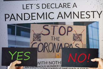 Symbolic image of Pandemic Amnesty: Section of a symbolic newspaper, signs reading YES and NO are