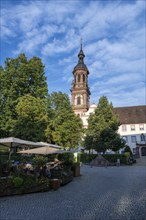 Outdoor catering in the Klosterstraße with the bell tower of the town church of St. Mary,