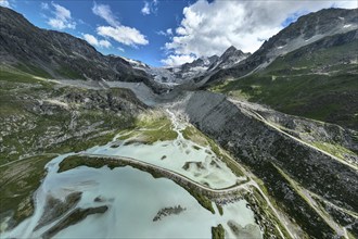 Glacial lake Lac de Chateaupre, lake just below the Moiry glacier, river arms in blue water, dam to