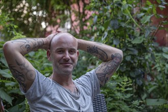 Portrait of a young man with tattooed arms, Baden-Württemberg, Germany, Europe