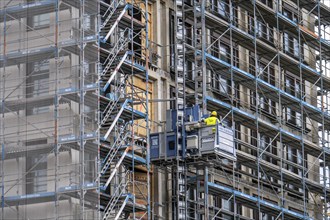 Construction site, construction site lift, new construction of a high-rise office building, facade