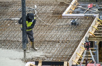 Construction site, concreting, the floor slab of a building is concreted, the concrete is pumped