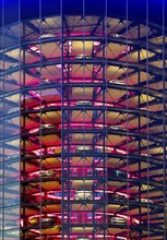 An illuminated car tower with new cars for delivery in the evening, detail, Autostadt, Volkswagen