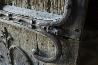 Orcival. Intricate Roman wrought iron hinge displayed at the Basilica Notre-Dame d'Orcival, Puy de