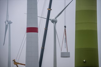 Construction of the tower of a wind power plant in a wind farm near Issum, 9 older wind turbines