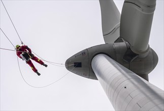 Height rescuers from the Oberhausen fire brigade practise abseiling from a wind turbine from a