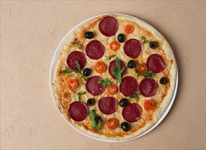 Pepperoni pizza, with olives and cherry, homemade, on a beige background, top view, no people