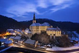 Winter evening in the Müglitz valley, impressively illuminated Weesenstein Castle at the blue hour,