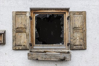 Window of a farmhouse destroyed by hail, storm on 26.8.23 near Benediktbeuern, Bavaria, Germany,