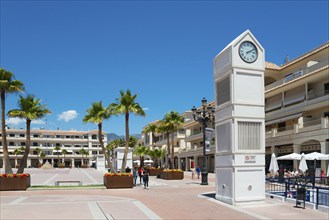 Modern square with clock tower and palm trees under a blue sky, Plaza de España, Nerja, Province of