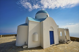 White church with blue dome and blue door under a clear Mediterranean sky, Church of Profitis