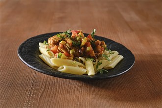 Beef ragout fried with vegetables and spicy sauce with pasta