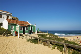 Colourful holiday homes and beach, Monte Clérigo, Atlantic coast, Algarve, Portugal, Europe