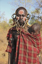 South Ethiopia, in Maco National Park, Mursi tribe, Mursi woman with baby, painted skin and