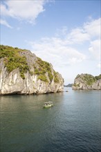 Fishing boat and the karst rocks in Lan Ha Bay, Halong Bay, Vietnam, Asia