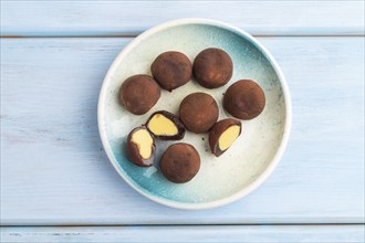 Japanese rice sweet buns chocolate mochi filled with cream on blue wooden background. top view,