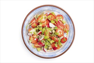 Vegetarian fruits and vegetables salad of strawberry, kiwi, tomatoes, microgreen sprouts isolated