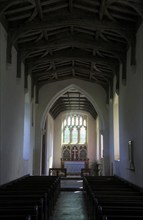 East window, nave and altar in All Saints church, Ellough, Suffolk, England, UK