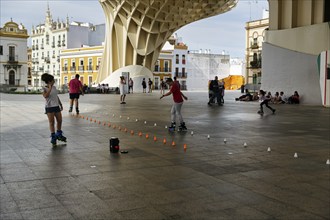 Inline skaters and pedestrians on the Plaza Mayor, Metropol Parasol, Seville, Andalusia, Spain,