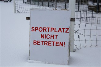 Symbolic image Football match cancellation due to snow. Sign on a sports field with the inscription