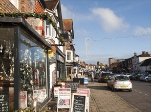 People shopping on historic High Street of Marlborough, Wiltshire, England, UK