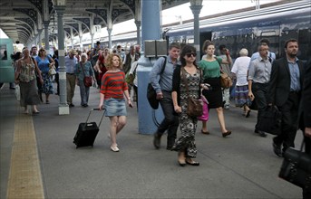 Crowd of passengers leaving their trains on the platform at Norwich railway station, Norfolk,