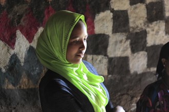 Young woman with headscarf in her round hut in the south of the country, Ethiopia, Africa