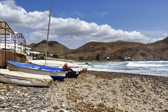 Fishing boats on a pebble beach, rocky coast, Cabo de Gata Natural Park, Las Negras, Almeria,