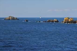 Evening view from the Pointe du Grouin with a view of the Phare de la Pierre-de-Herpin and striking