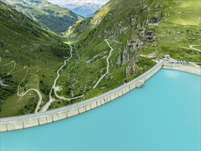 Dam of the Moiry lake, Lac de Moiry, turquoise glacial water, parking lot and restaurant at the