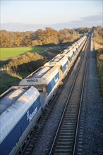 Open waggons of freight train on the West Coast mainline at Woodborough, Wiltshire, England, UK