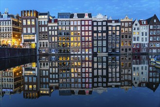 Canal houses on the Damrak, in the centre of the old town of Amsterdam, harbour, starting point of