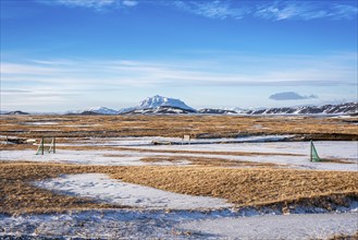 View over snow-covered football playground towards Mt. Herdubreid, winter, farm Mödrudalur, located