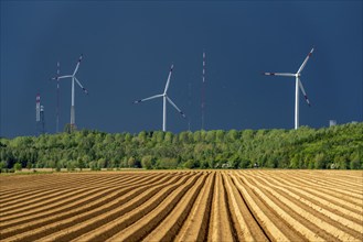 Wind turbines on the Grevenbroich wind test field, dark rain clouds, in the Rhenish lignite mining