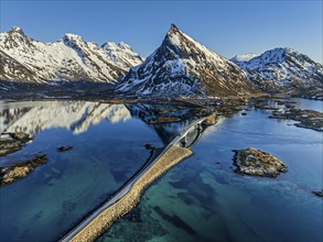 Aerial view of bridge, fjord, steep mountains, coast, winter, evening light, reflection,