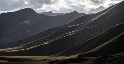 Mountain silhouette and hills in the sunlight, Dramatic mountain landscape, Tian Shan, Sky