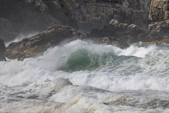 Large waves of the Atlantic Ocean crash against the rocks of a cliff. Camaret sur mer, Crozon,