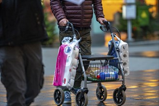 Man with rollator buys 2 large packs of toilet paper, The city centre of Bochum, on the day of the