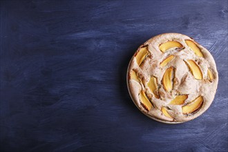 Sweet persimmon pie on black wooden background. top view, copy space