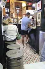 Customers inside famous historic Los Gatos Cervecerias bar, Madrid city centre, Spain, Europe