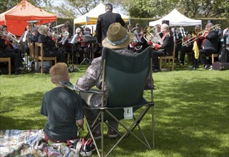 People watching a brass band perform during a country fair, Helmingham Hall, Suffolk, England,