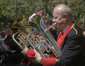 Musicians in a brass band perform during a country fair at Helmingham Hall, Suffolk, England,