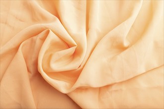 Fragment of orange linen tissue. Top view, flat lay, natural textile background and texture. wave