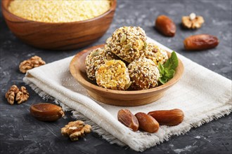 Energy ball cakes with dried apricots, sesame, cornflakes, linen, walnuts and dates with green mint