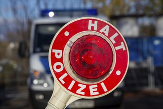 Police check: close-up of a police trowel with the inscription HALT POLIZEI in front of a police