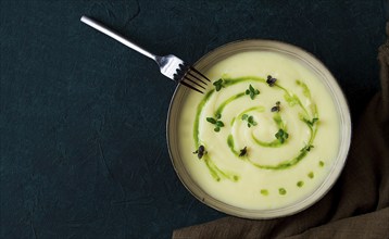 Mashed potatoes, with green butter, micro greenery, homemade, on a dark background, no people, top