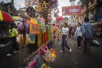 Vendor sells toys and other children items at a street market ahead of Durga Puja festival on