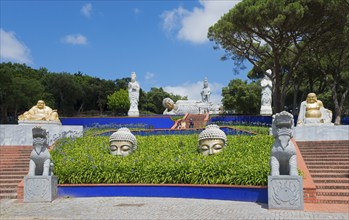 Spiritual garden with several Buddha statues and plants, radiating peace and tranquillity under a