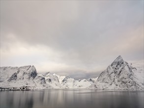 Snowy mountains by the fjord, Hamnøy, Reine, Moskenesøya, Lofoten, Norway, Europe