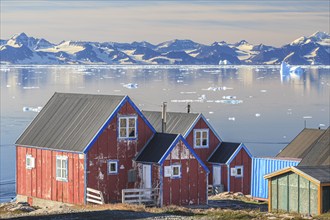 Typical Greenlandic house in an Inuit settlement on a fjord off Bergen, sunny, Ittoqqortoormiit,